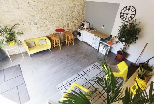 an overhead view of a living room with yellow and white furniture at Chez Waucquier in Beaucaire