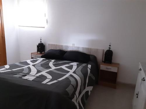 a bedroom with a bed and two night stands at JARAMUNDI in Villa del Prado