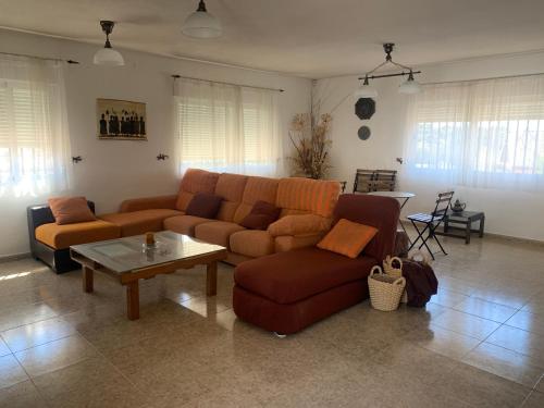 a living room with a couch and a table at JARAMUNDI in Villa del Prado