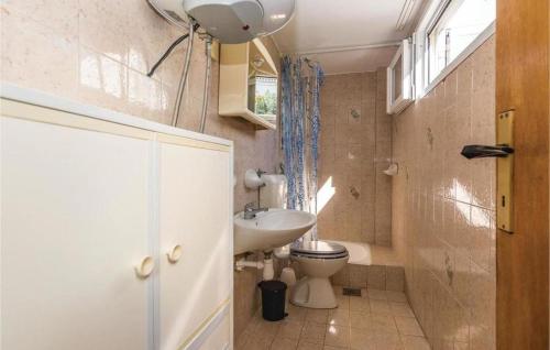 a small bathroom with a toilet and a sink at Apartmani L&Z in Petrcane