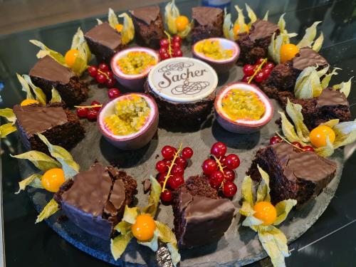 a plate of chocolate desserts with fruit on it at Romantikschlössl Loipersdorf Adults Only in Grieselstein