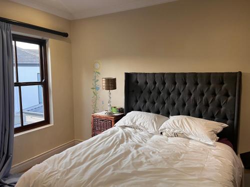 a bedroom with a large bed and a window at Jambase Seaside House in Big Bay