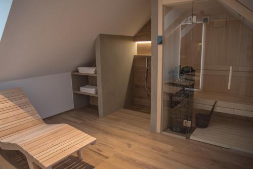 a living room with a wooden chair and a closet at Vila De Casa in Ribnica