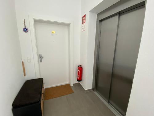 a hallway with a door and a fire extinguisher at Moderne Kaminstube in Ramsau am Dachstein