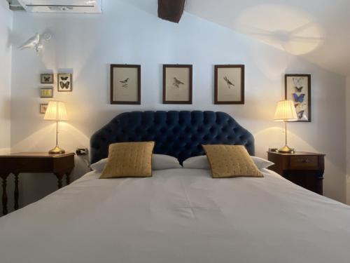 un grande letto blu con due comodini e due lampade di Ponte del Mera Attic a Chiavenna