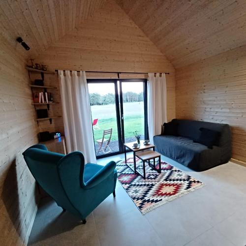 a living room with a couch and a window at Makówka in Stromiec