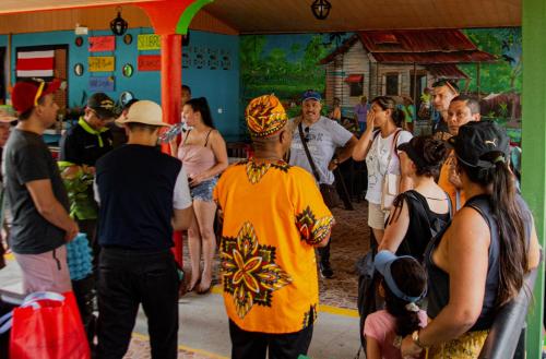 a group of people standing outside of a building at Hotel El Icaco Tortuguero in Tortuguero
