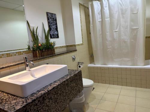 a bathroom with a sink and a toilet at Business Backpackers JBR (BBJ) in Dubai