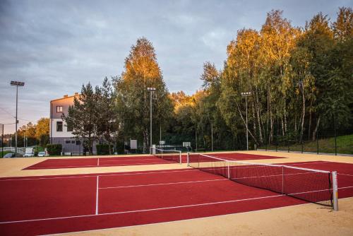 a tennis court with two tennis nets on it at Pawilon Sportowo Turystyczny Kalwarianka in Kalwaria Zebrzydowska