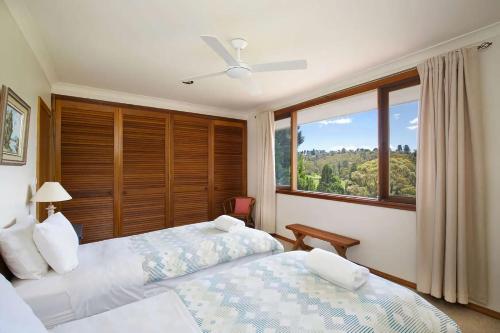 a bedroom with two beds and a window at Stableford Lodge in Blackheath