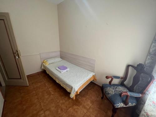 a small room with a small bed and a chair at Alma In the heart of the Vilaflor! Self check in 24h in Vilaflor