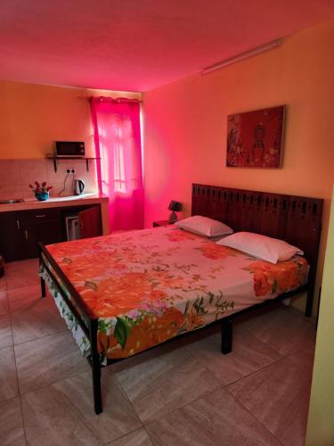 a bedroom with a large bed with pink lighting at Bob Apartments in Calodyne