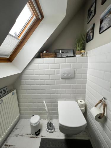 a bathroom with a white toilet and a sink at Ankerplatz Güby in Güby