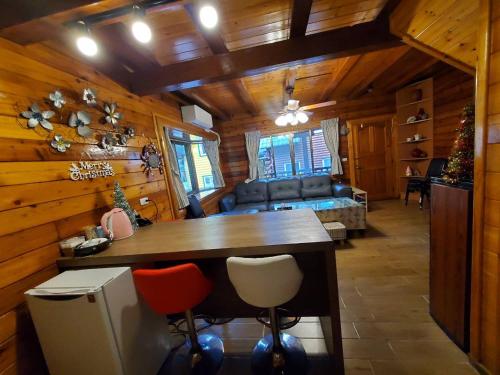 a kitchen and living room in a log cabin at 秋憶木屋 in Gukeng