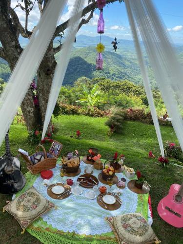 a picnic table with food on it in a tent at Pousada Le Monte Cristo in Guaramiranga