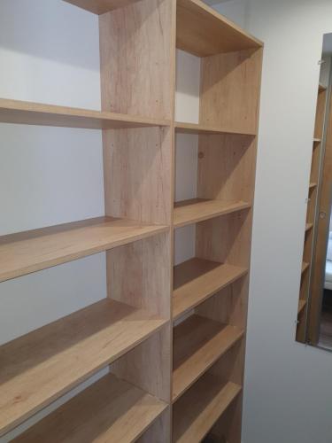 a wooden book shelf in a room at Mobilhome camping le MAR ESTANG in Canet-en-Roussillon