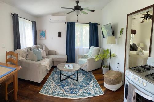 a living room with a couch and a table at Hummingbirds Cabins in Caye Caulker