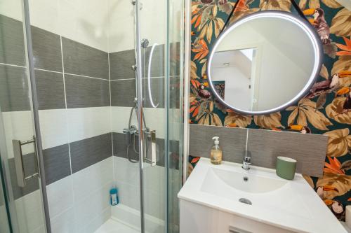 a bathroom with a shower and a sink and a mirror at LE ARA - Gare - centre ville - By Nid'Ouest in Quimper