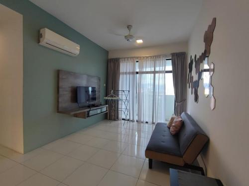 a living room with a couch and a television at Mint Cabin @ Oasis Condo Ipoh in Ipoh