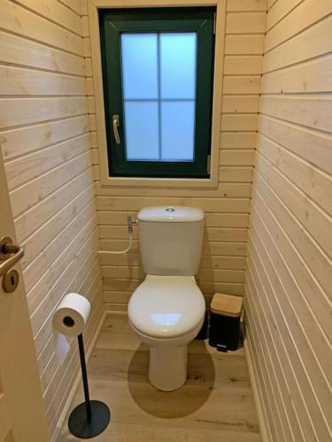 a small bathroom with a toilet and a window at La Roulotte du Moulin de Rebets in Rebets