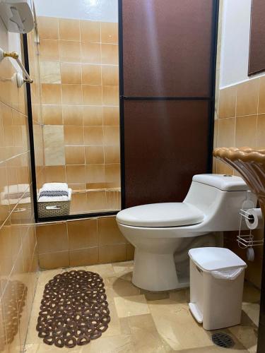 a bathroom with a toilet and a shower at Departamento amoblado centro Manta in Manta