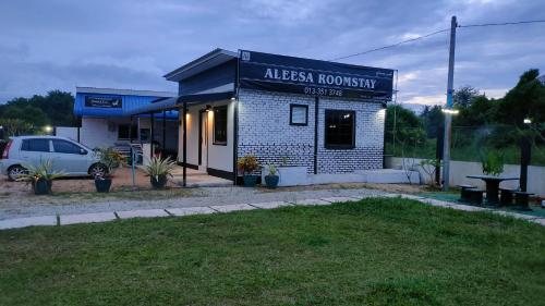 a building with a sign that reads alaskan honesty at Aleesa Roomstay & Hotel in Pasir Puteh
