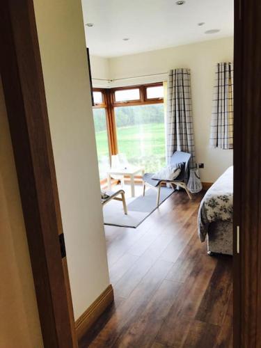 a bedroom with a bed and a living room at Coby's Corner, Darney Rd Bruckless in Bruckless