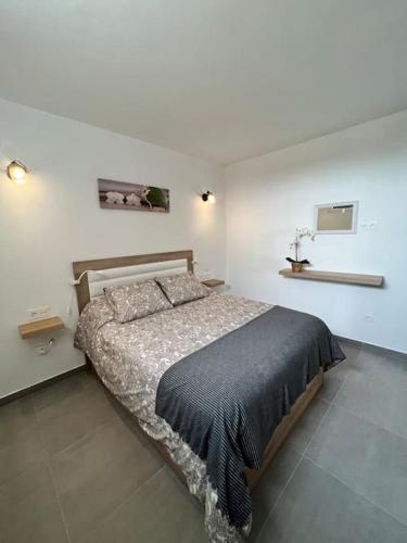 a bedroom with a bed in a white room at El Cercado in Tinajo