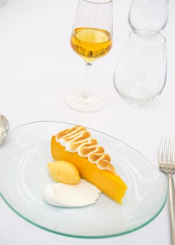 a banana on a plate with a glass of wine at Titchwell Manor Hotel in Titchwell