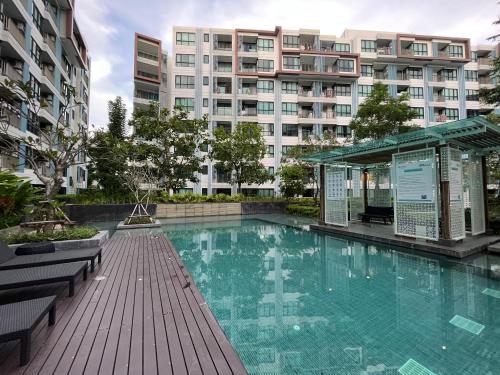 a large swimming pool in front of a building at 1 bedroom Centrio Condominium Phuket Near Central Festival in Phuket town in Phuket