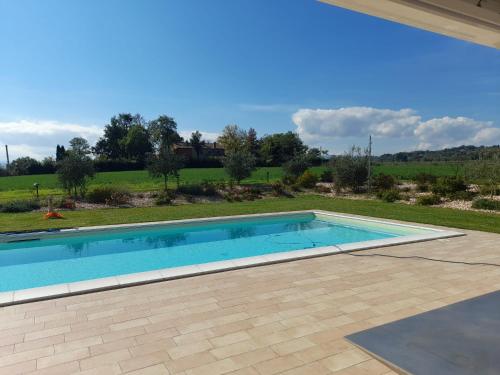 a swimming pool in the backyard of a house at Villa Sofia in Calcinelli