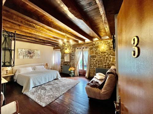 a bedroom with a bed and a stone wall at Casa Rural Irigoien in Donostia-San Sebastián