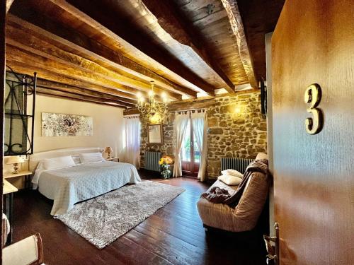 um quarto com uma cama e uma parede de pedra em Casa Rural Irigoien em San Sebastián