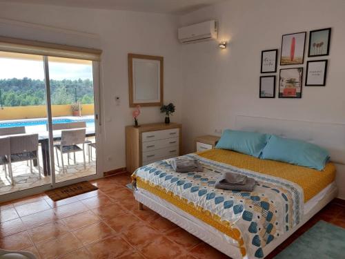 a bedroom with a bed and a balcony with a pool at Buena Vista in L'Ametlla de Mar