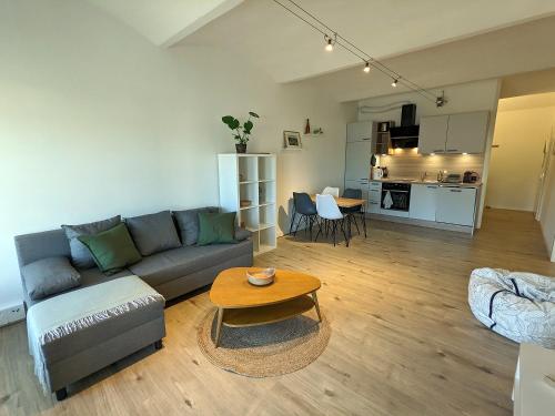 a living room with a couch and a table at Alte Brauerei Buchs in Buchs