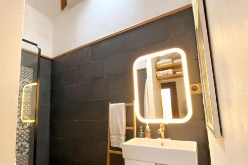 a bathroom with a sink and a mirror at Oporto City Chalé in Porto