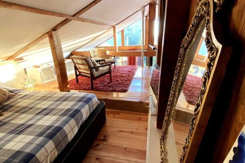 a bedroom with a bed and a table and a chair at Oporto City Chalé in Porto