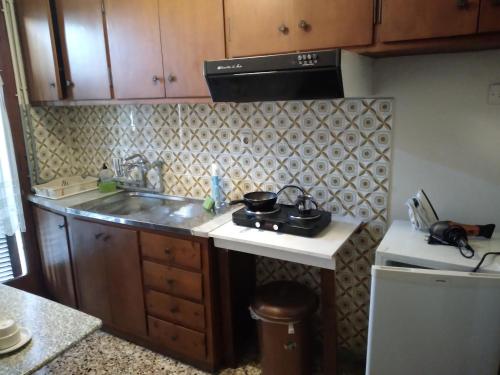 a small kitchen with a sink and a stove at FILIPPOS-Spectacular area,,,,panoramic,-sea- view- apartments-49m2- with private parking just call for price,vacancy etc,,-next to Vallis hotel,, 15meters from seaside!!! in Agria