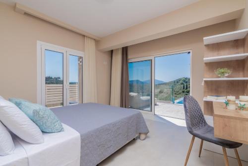 a bedroom with a bed and a large window at Spartakos Luxury Villa 3 in Planos