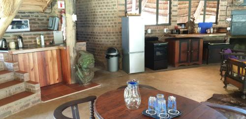 a kitchen with a wooden table and a refrigerator at The Lapa in Durban