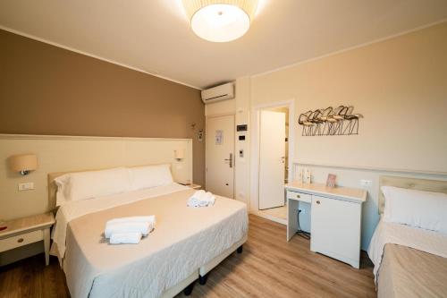 Postel nebo postele na pokoji v ubytování Hotel Orchidea