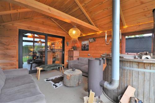 una sala de estar de una cabaña de madera con chimenea en Duizend en één nacht en Beernem