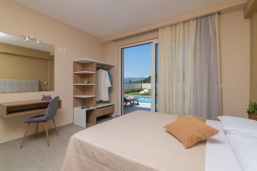 a bedroom with a bed and a desk and a window at Spartakos Luxury Villa 4 in Plános