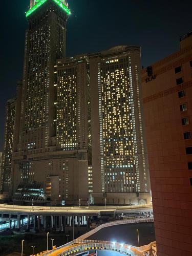 a large building with lights in front of it at night at Royal Majestic Hotel Makkah in Makkah