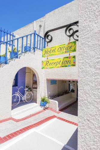 a building with a sign for a hotel office repeat lot at Nissia Kamares in Kardamaina
