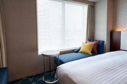 Un ou plusieurs lits dans un hébergement de l'établissement Hotel GrandConsort Naha