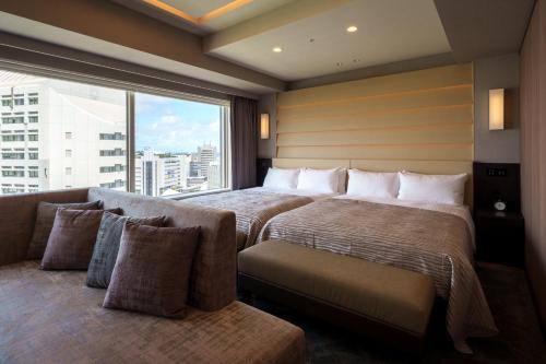 Un ou plusieurs lits dans un hébergement de l'établissement Hotel GrandConsort Naha