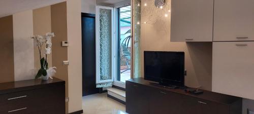 a living room with a tv and a window at La terrazza dell' Angelo in Pomarico