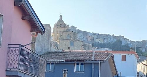 a view of a building with a hill in the background at La terrazza dell' Angelo in Pomarico