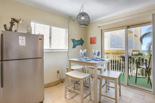 a kitchen with a refrigerator and a table and chairs at 201 Belleair Beach Club in Clearwater Beach